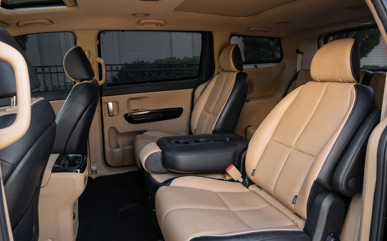 Second-row captain chairs in a Kia Carnival prepared for executive transportation